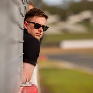 Man with sunglasses watching the race track