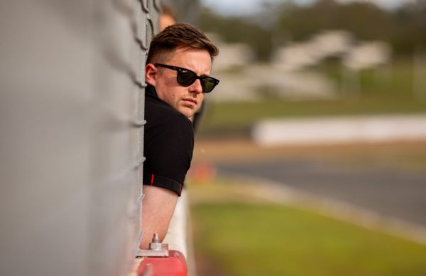 Man with sunglasses watching the race track